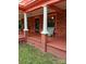 Covered front porch with classic columns, a rocking chair, and a welcoming entrance at 514 N Main St, Mount Gilead, NC 27306