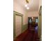 Hallway with hardwood floors, wainscoting, and views into adjoining rooms at 514 N Main St, Mount Gilead, NC 27306