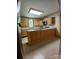 Bright kitchen featuring light wood cabinets, an island with granite countertops, and stainless steel appliances at 514 N Main St, Mount Gilead, NC 27306