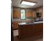 Bright kitchen featuring light wood cabinets, an island with granite countertops, and stainless steel appliances at 514 N Main St, Mount Gilead, NC 27306
