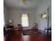 Bright living room with large windows, hardwood floors and a fireplace for a cozy ambiance at 514 N Main St, Mount Gilead, NC 27306