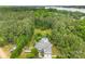 Aerial view of a home in a lush, green landscape with a pool, lake in distance, and two car garage at 5418 Commodore Pl, Clover, SC 29710