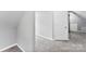 Finished attic space with plush carpeting and an adjacent storage area featuring a full-sized access door at 5418 Commodore Pl, Clover, SC 29710