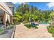 This backyard features a large patio surrounding a luxurious pool, perfect for entertaining at 5418 Commodore Pl, Clover, SC 29710
