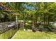 Backyard featuring outdoor grill, arbor leading to yard and pool area, and lush green surroundings at 5418 Commodore Pl, Clover, SC 29710