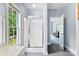 Bright bathroom with shower featuring glass doors and a window that brings in natural light at 5418 Commodore Pl, Clover, SC 29710