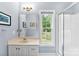 Bathroom featuring sleek vanity, a large mirror, natural light, and a pristine, glass-enclosed shower at 5418 Commodore Pl, Clover, SC 29710