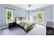 Bedroom with two windows and French doors, complemented by an elegant black dresser and plush carpeting at 5418 Commodore Pl, Clover, SC 29710