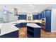 Stylish kitchen featuring bold blue cabinetry, stainless steel appliances, and a quartz countertop island at 5418 Commodore Pl, Clover, SC 29710