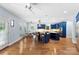 Bright kitchen offers custom blue cabinets, hardwood floors, and breakfast nook at 5418 Commodore Pl, Clover, SC 29710