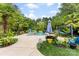 A luxurious outdoor pool area surrounded by lush landscaping and lounge seating at 5418 Commodore Pl, Clover, SC 29710