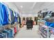 Large walk-in closet featuring extensive shelving, hanging space, and a central seating area with a dresser at 5418 Commodore Pl, Clover, SC 29710
