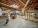 Unfinished basement with exposed ceiling, concrete floors, and potential for future renovations at 55 Dixie Dr, Taylorsville, NC 28681