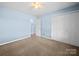 Bedroom with neutral carpet, a closet with double doors, and light blue walls that create a calming atmosphere at 55 Dixie Dr, Taylorsville, NC 28681