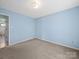 A serene bedroom featuring light blue walls, neutral carpeting, and a classic flush mount light fixture at 55 Dixie Dr, Taylorsville, NC 28681