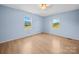 A spacious bedroom features wood floors and sunny windows showcasing a nice view at 55 Dixie Dr, Taylorsville, NC 28681