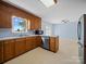 Functional kitchen boasts wood cabinets, tile floors, and a breakfast bar area at 55 Dixie Dr, Taylorsville, NC 28681