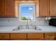 A stainless steel kitchen sink sits beneath a window in this well-lit kitchen at 55 Dixie Dr, Taylorsville, NC 28681