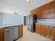 Kitchen with wood cabinetry, updated stainless-steel appliances, and tile flooring at 55 Dixie Dr, Taylorsville, NC 28681