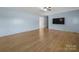 Open living area with hardwood floors, light blue walls, and a mounted flat screen TV at 55 Dixie Dr, Taylorsville, NC 28681