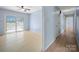 A bright living room opens to a hallway and features a sliding glass door to the outside at 55 Dixie Dr, Taylorsville, NC 28681