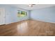 Bright living room with light blue walls, hardwood floors, and a large window at 55 Dixie Dr, Taylorsville, NC 28681