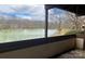Balcony view to the lake with fountains, trees in background and frame view of balcony in foreground at 5718 Dockside Dr, Charlotte, NC 28227
