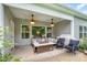Covered back patio with ceiling fans, stylish seating, and a grill for outdoor relaxation and entertainment at 6309 Fawn Crest Dr, Waxhaw, NC 28173