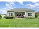 Well-maintained backyard with a covered patio and flourishing greenery offers a serene outdoor space at 6309 Fawn Crest Dr, Waxhaw, NC 28173