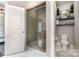 Modern bathroom with a glass-enclosed shower and decorative shelving above the toilet at 6309 Fawn Crest Dr, Waxhaw, NC 28173