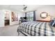 Bright bedroom with a plaid comforter, neutral walls, and an en suite bathroom at 6309 Fawn Crest Dr, Waxhaw, NC 28173