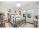 Comfortable bedroom showcasing a decorative bed, bright windows, and patterned curtains at 6309 Fawn Crest Dr, Waxhaw, NC 28173