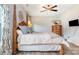Traditional bedroom featuring a grand canopy bed, wood floors, and a stylish ceiling fan with chandelier at 6309 Fawn Crest Dr, Waxhaw, NC 28173