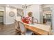 Bright dining room with wood floors and table; stairway in view at 6309 Fawn Crest Dr, Waxhaw, NC 28173