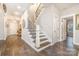 Bright foyer showcases hardwood floors, staircase with iron railing, and open floor plan at 6309 Fawn Crest Dr, Waxhaw, NC 28173