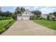 View of the exterior featuring a long driveway and manicured front lawn at 6309 Fawn Crest Dr, Waxhaw, NC 28173