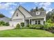 Lovely home with three-car garage, lush landscaping, and a welcoming front porch at 6309 Fawn Crest Dr, Waxhaw, NC 28173