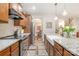 Kitchen with a view of the dining room; features stainless steel appliances, granite countertops and wood floors at 6309 Fawn Crest Dr, Waxhaw, NC 28173