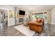Comfortable living room features a stone fireplace, hardwood floors, and stylish furnishings at 6309 Fawn Crest Dr, Waxhaw, NC 28173
