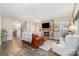 Bright and airy living room with stone fireplace, hardwood floors, and staircase access at 6309 Fawn Crest Dr, Waxhaw, NC 28173