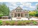 Backyard features a covered patio, outdoor seating, fire pit, and built-in grill and counter at 6831 Conservatory Ln, Charlotte, NC 28210