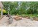 Beautiful backyard featuring a stone patio with a fire pit and comfortable seating for outdoor entertaining at 6831 Conservatory Ln, Charlotte, NC 28210