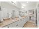 Bright bathroom featuring double sinks with granite counters and access to bedroom at 6831 Conservatory Ln, Charlotte, NC 28210