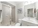 Well-lit bathroom with a glass-enclosed shower, a single sink vanity, and neutral tile flooring at 6831 Conservatory Ln, Charlotte, NC 28210