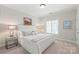 Bedroom featuring large bed with gray pillows and shuttered windows at 6831 Conservatory Ln, Charlotte, NC 28210