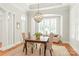 Cozy dining room featuring natural light, neutral paint, and a traditional light fixture above the wooden table at 6831 Conservatory Ln, Charlotte, NC 28210