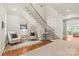 Bright foyer with a grand staircase, hardwood floors, and elegant decor, creating a welcoming entrance at 6831 Conservatory Ln, Charlotte, NC 28210