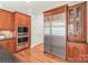 Gourmet kitchen with cherry cabinets, stainless steel appliances, and an adjacent pantry for efficient storage at 6831 Conservatory Ln, Charlotte, NC 28210