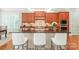 Beautiful kitchen island with granite countertops, seating, and ample storage, perfect for food preparation at 6831 Conservatory Ln, Charlotte, NC 28210