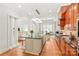 Bright kitchen with wood floors, stainless steel appliances, island with breakfast bar, and easy access to the living room at 6831 Conservatory Ln, Charlotte, NC 28210